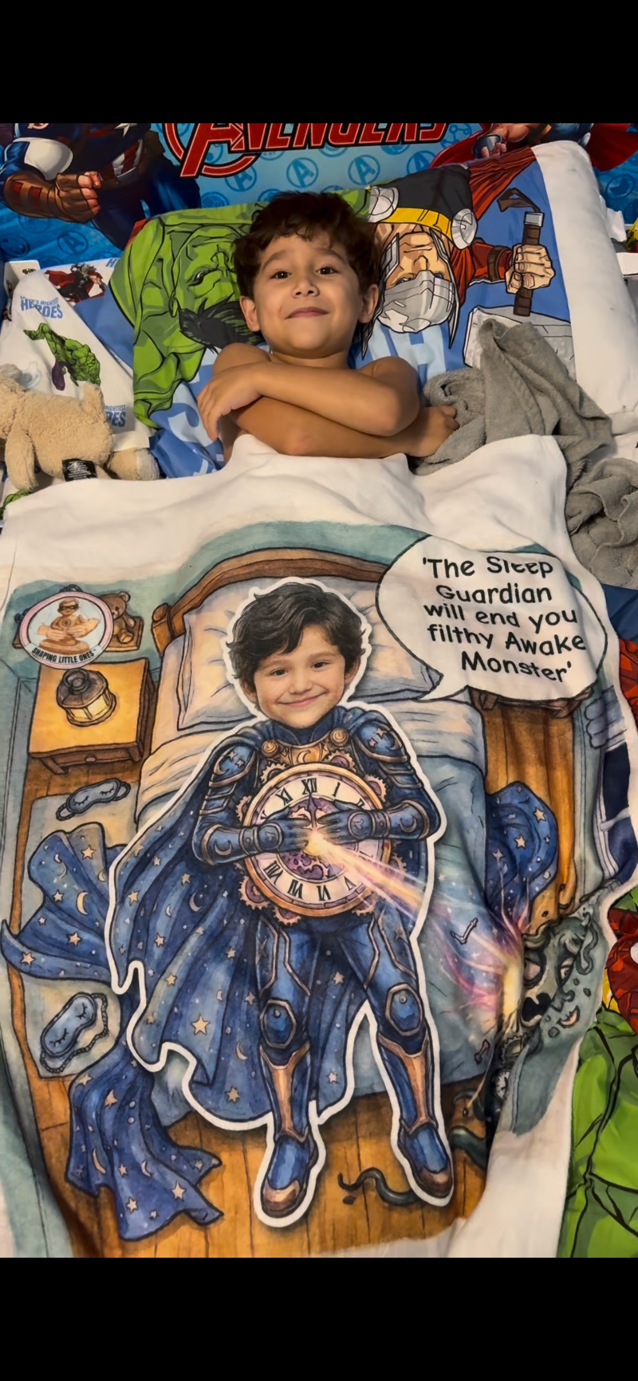 Boy tucked into bed with his Sleep Guardian blanket